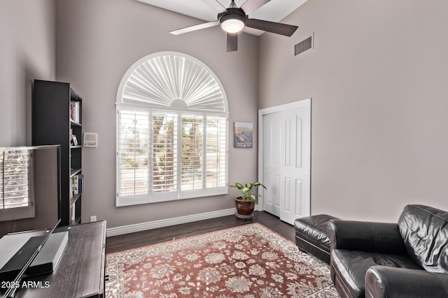 3733 E Kachina Dr, Phoenix, AZ 85044 - living room featuring a ceiling fan, a high ceiling, baseboards, and dark wood-type flooring