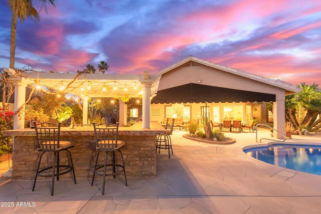 3733 E Kachina Dr, Phoenix, AZ 85044 - pool at dusk featuring an outdoor pool and a patio area