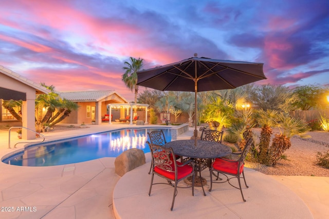 3733 E Kachina Dr, Phoenix, AZ 85044 - pool at dusk with a patio area, outdoor dining space, and a pergola