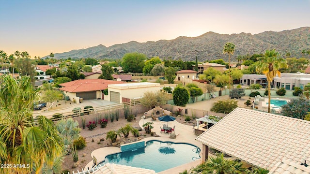 3733 E Kachina Dr, Phoenix, AZ 85044 - pool at dusk featuring a fenced backyard, a mountain view, and a patio