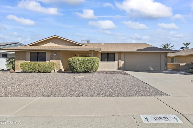 ranch-style home featuring a garage