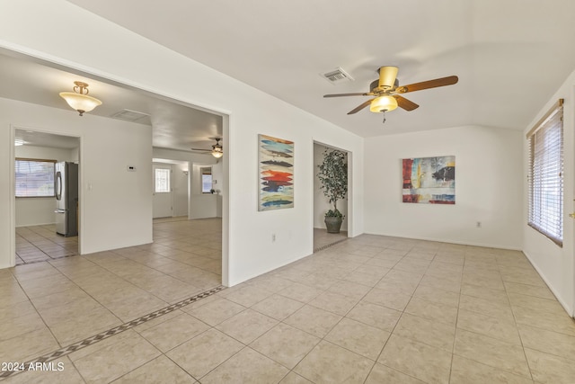 tiled spare room with plenty of natural light and ceiling fan