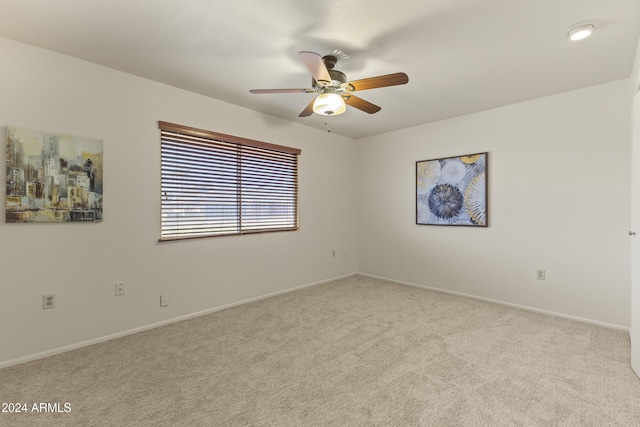 unfurnished room featuring ceiling fan and light colored carpet