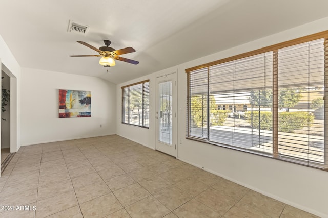 unfurnished room with ceiling fan, light tile patterned floors, and vaulted ceiling