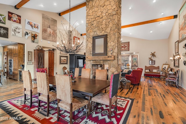 51238 N Pinal Ranch Rd, Miami, AZ 85539 - dining area with high vaulted ceiling, a notable chandelier, a fireplace, wood finished floors, and beamed ceiling