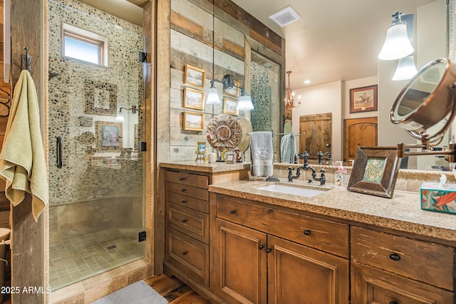 51238 N Pinal Ranch Rd, Miami, AZ 85539 - bathroom with visible vents, a shower stall, vanity, and wood finished floors