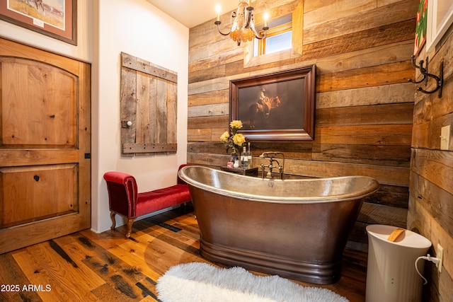 51238 N Pinal Ranch Rd, Miami, AZ 85539 - full bath featuring a freestanding bath, wood walls, wood finished floors, and a notable chandelier