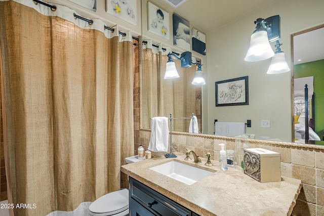 51238 N Pinal Ranch Rd, Miami, AZ 85539 - bathroom with vanity, toilet, and decorative backsplash