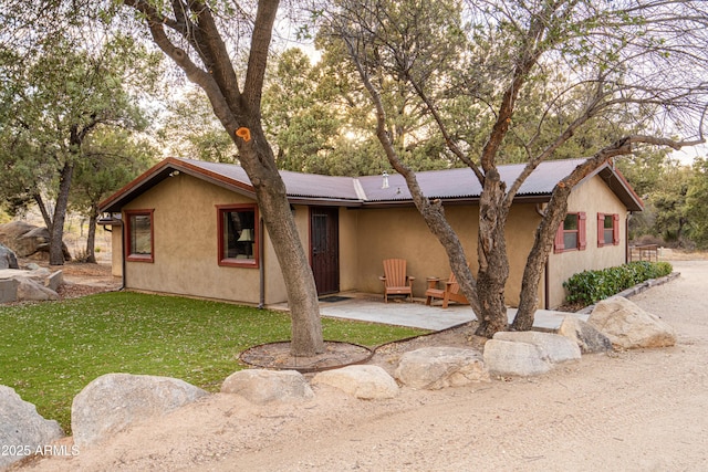 51238 N Pinal Ranch Rd, Miami, AZ 85539 - single story home with stucco siding, a front lawn, and a patio