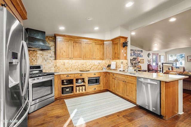 51238 N Pinal Ranch Rd, Miami, AZ 85539 - kitchen with wall chimney exhaust hood, appliances with stainless steel finishes, dark wood-type flooring, a peninsula, and vaulted ceiling with beams