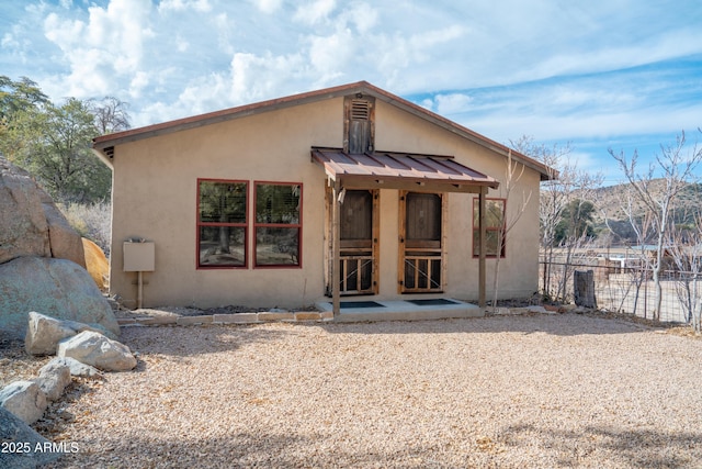 51238 N Pinal Ranch Rd, Miami, AZ 85539 - view of front facade featuring metal roof, a standing seam roof, fence, and stucco siding
