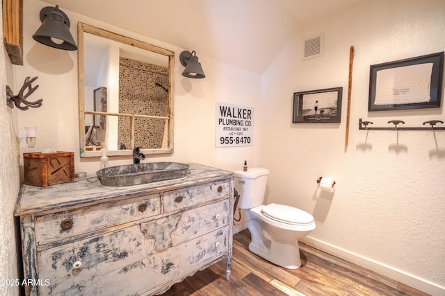 51238 N Pinal Ranch Rd, Miami, AZ 85539 - bathroom with visible vents, toilet, wood finished floors, vaulted ceiling, and vanity