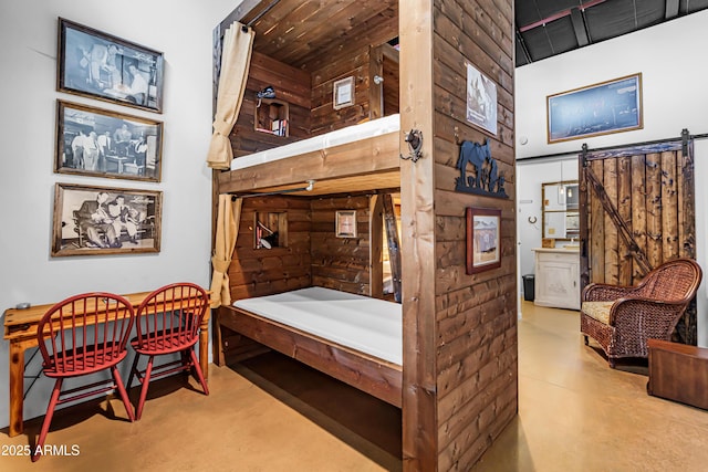 51238 N Pinal Ranch Rd, Miami, AZ 85539 - bedroom with a barn door, a high ceiling, and finished concrete floors