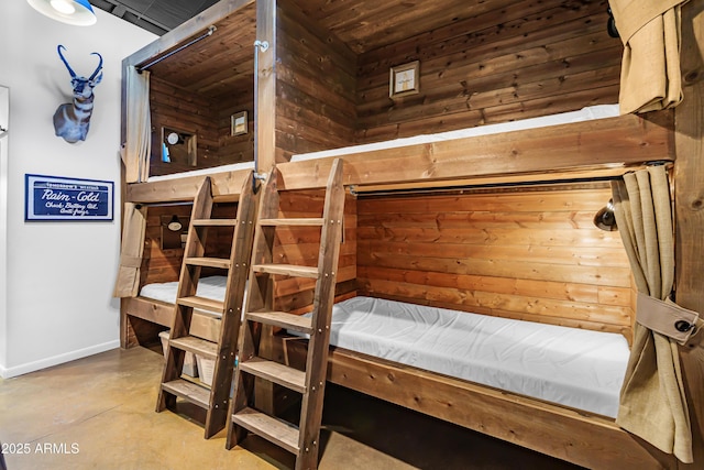 51238 N Pinal Ranch Rd, Miami, AZ 85539 - bedroom with concrete flooring, baseboards, and wooden walls