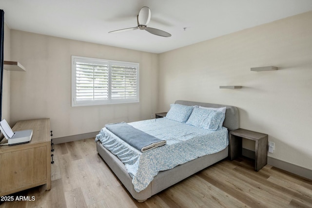 bedroom with baseboards, a ceiling fan, and wood finished floors