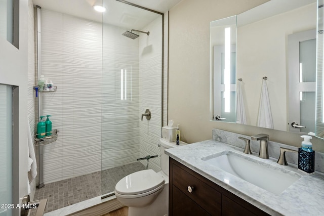 bathroom with vanity, walk in shower, and toilet