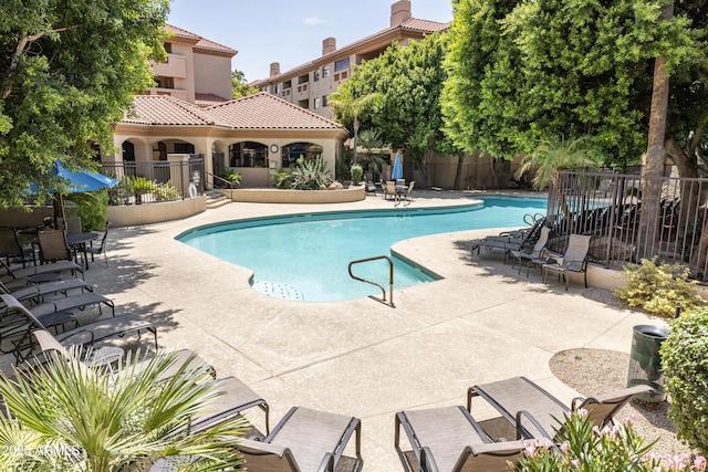 community pool featuring a patio area and fence