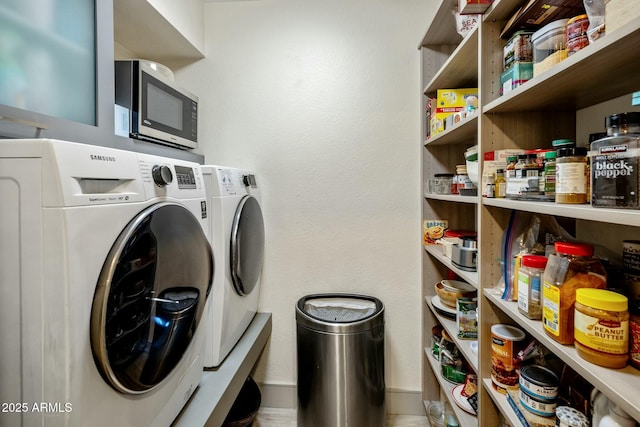 laundry area featuring baseboards, laundry area, and washing machine and clothes dryer