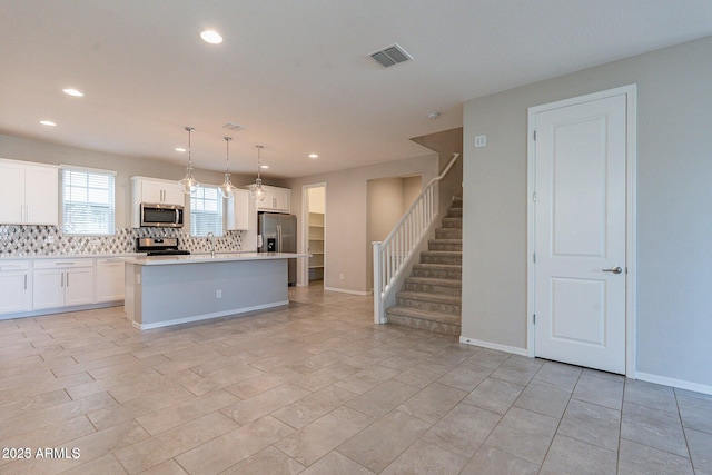 613 W Winchester Dr, Chandler, AZ 85286 - kitchen featuring appliances with stainless steel finishes, decorative backsplash, a center island with sink, recessed lighting, and a sink