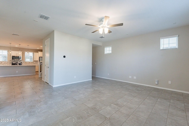613 W Winchester Dr, Chandler, AZ 85286 - unfurnished room featuring ceiling fan, plenty of natural light, and baseboards