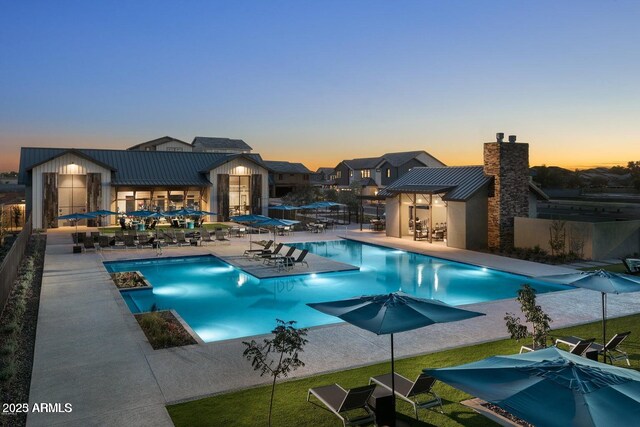 613 W Winchester Dr, Chandler, AZ 85286 - pool at dusk featuring a patio area and a community pool