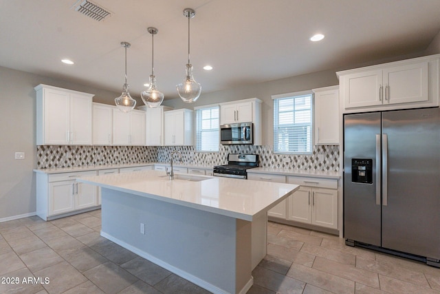 613 W Winchester Dr, Chandler, AZ 85286 - kitchen featuring stainless steel appliances, tasteful backsplash, a sink, light countertops, and white cabinetry