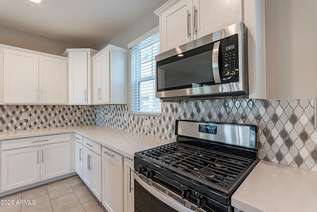 613 W Winchester Dr, Chandler, AZ 85286 - kitchen featuring stainless steel appliances, light countertops, white cabinetry, light tile patterned floors, and backsplash