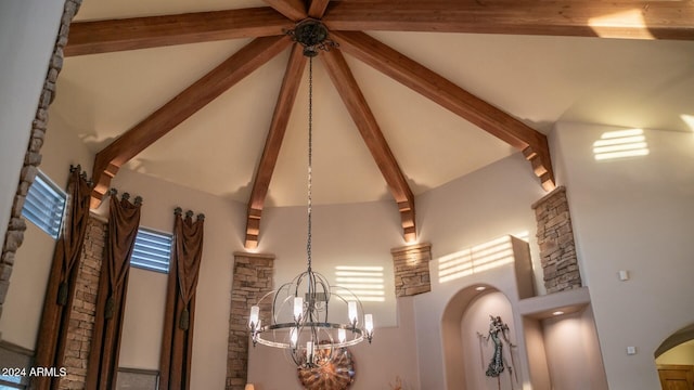 interior details with beamed ceiling and a chandelier