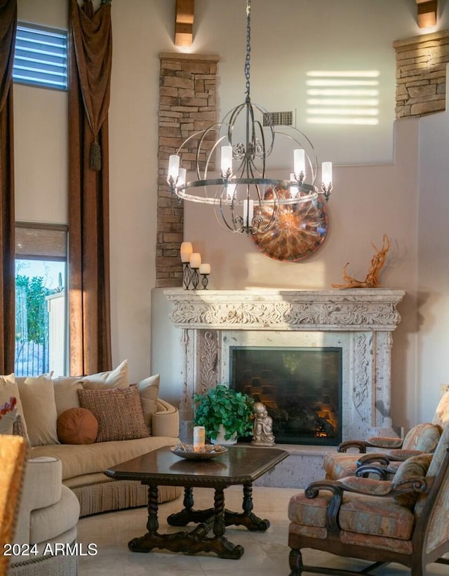 living room featuring a high end fireplace and an inviting chandelier