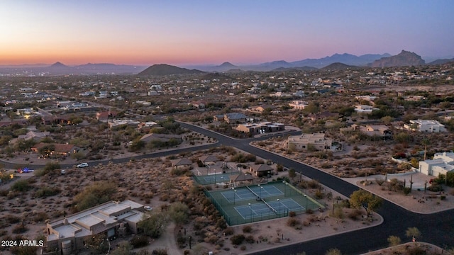 aerial view at dusk featuring a mountain view