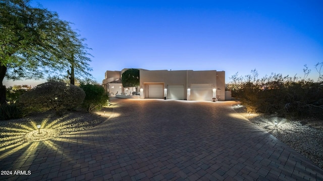 pueblo revival-style home with a garage