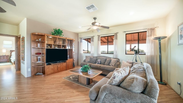 living room with ceiling fan and light wood-type flooring