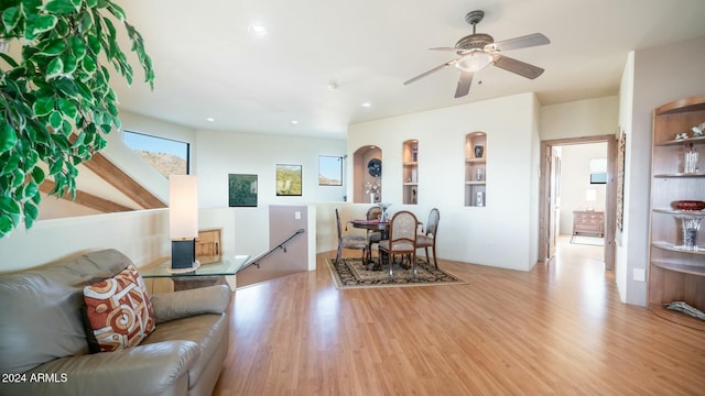 living room featuring ceiling fan and light hardwood / wood-style floors