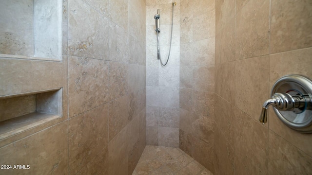 interior details featuring tiled shower