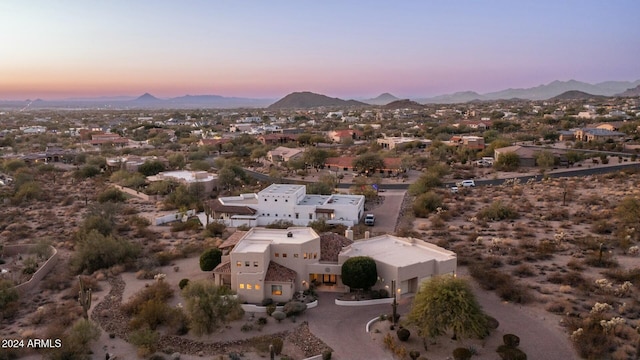 aerial view at dusk featuring a mountain view