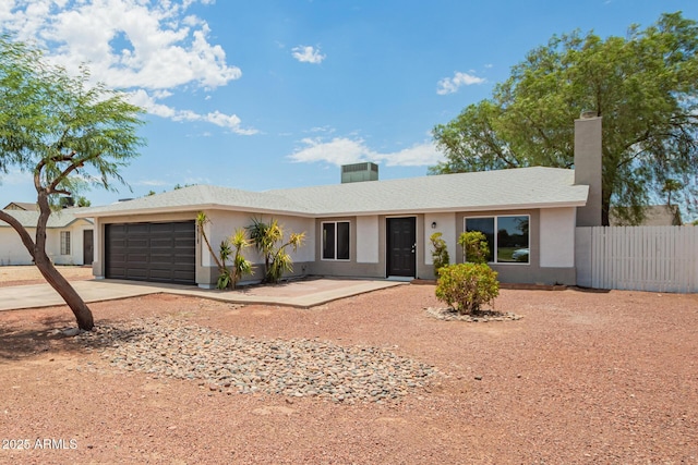 2318 N 87th Ave, Phoenix, AZ 85037 - ranch-style house featuring a garage, stucco siding, concrete driveway, and a chimney
