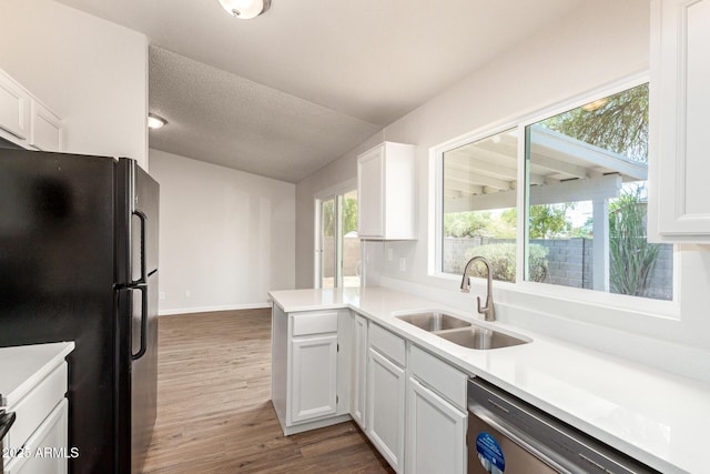 2318 N 87th Ave, Phoenix, AZ 85037 - kitchen featuring freestanding refrigerator, dishwasher, white cabinets, dark wood-type flooring, and light countertops