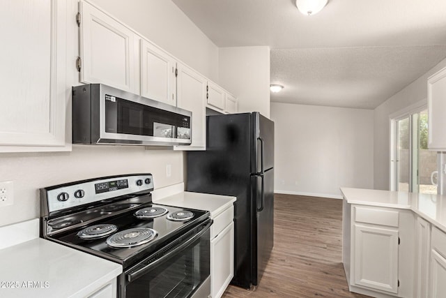 2318 N 87th Ave, Phoenix, AZ 85037 - kitchen with black appliances, white cabinets, light countertops, wood finished floors, and a textured ceiling