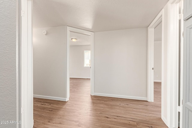 2318 N 87th Ave, Phoenix, AZ 85037 - hallway with wood finished floors and a textured ceiling