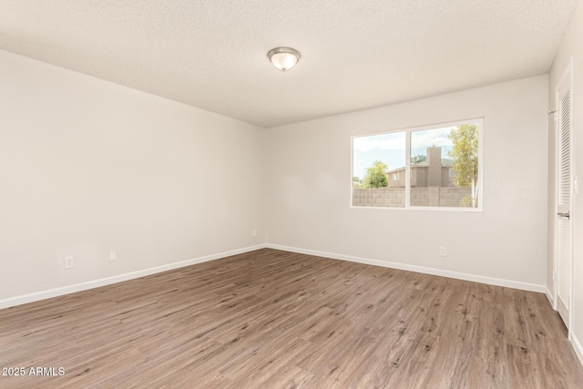 2318 N 87th Ave, Phoenix, AZ 85037 - spare room with light wood-type flooring and a textured ceiling
