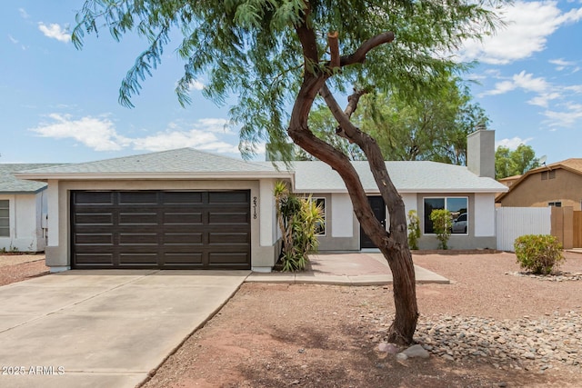 2318 N 87th Ave, Phoenix, AZ 85037 - ranch-style house with concrete driveway, a chimney, stucco siding, and an attached garage