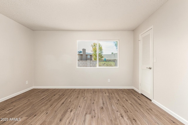 2318 N 87th Ave, Phoenix, AZ 85037 - empty room with wood finished floors and a textured ceiling
