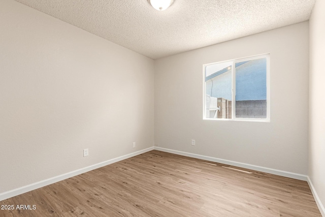 2318 N 87th Ave, Phoenix, AZ 85037 - empty room with light wood-type flooring and a textured ceiling