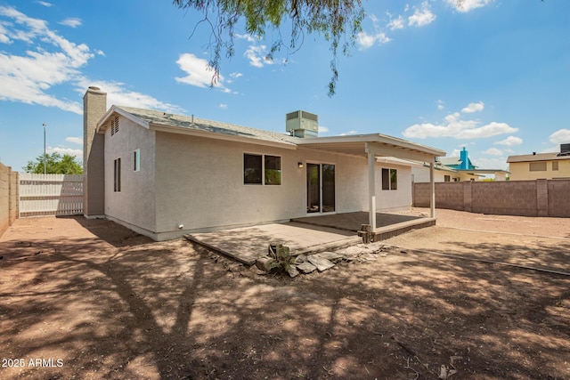 2318 N 87th Ave, Phoenix, AZ 85037 - rear view of property with a patio, a fenced backyard, a chimney, and stucco siding