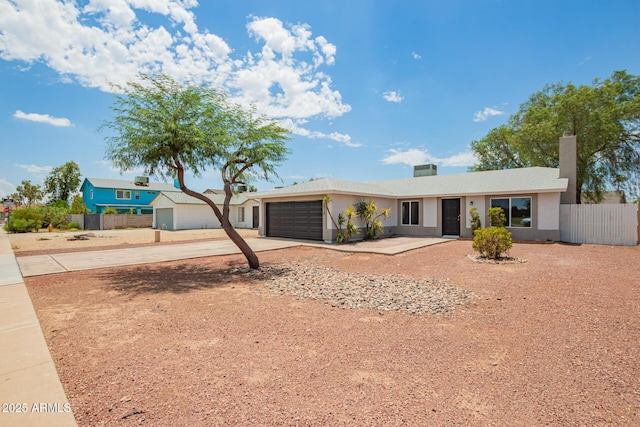 2318 N 87th Ave, Phoenix, AZ 85037 - ranch-style house with concrete driveway, a garage, and stucco siding