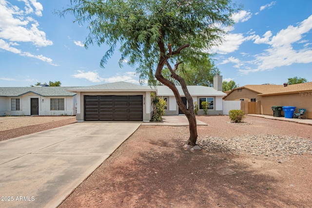 2318 N 87th Ave, Phoenix, AZ 85037 - ranch-style home featuring an attached garage, concrete driveway, stucco siding, and a chimney