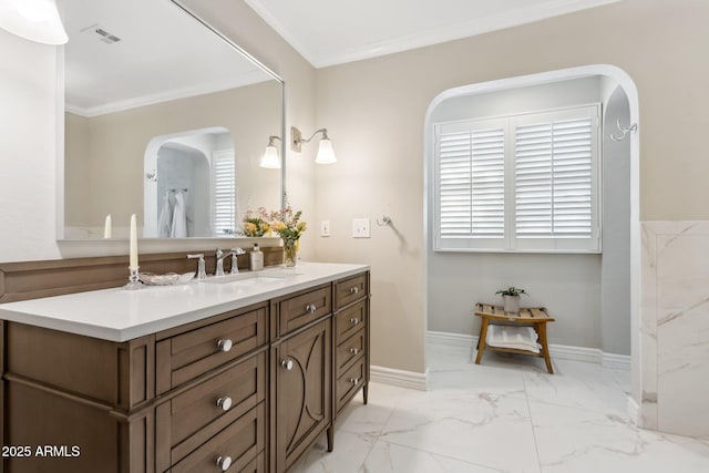 bathroom with crown molding and vanity