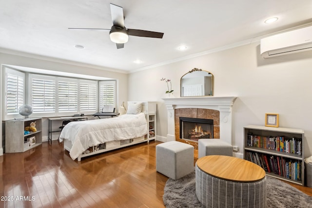 bedroom featuring hardwood / wood-style flooring, ornamental molding, and an AC wall unit