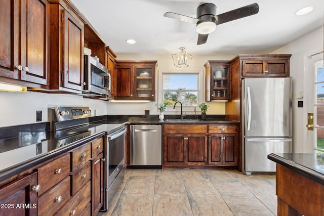 kitchen featuring sink, ceiling fan with notable chandelier, and stainless steel appliances