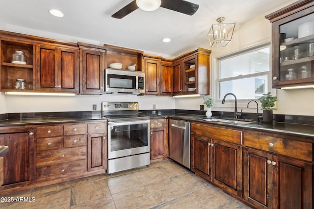 kitchen featuring appliances with stainless steel finishes, sink, and ceiling fan